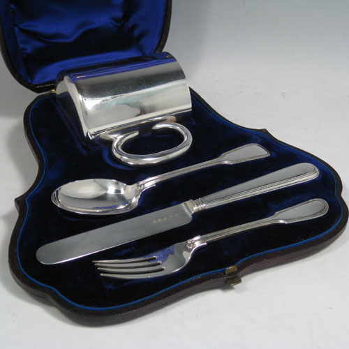 Antique Victorian sterling silver christening set consisting of a plain christening mug with loop handle, and a knife, fork, and spoon in the Fiddle and Thread pattern, all in original blue satin and velvet-lined presentation box. Made by the Savory Brothers of London in 1879. Height of mug 8 cms (3 inches), length of knife 19 cms (7.5 inches). Total weight approx. 251g (8 troy ounces).