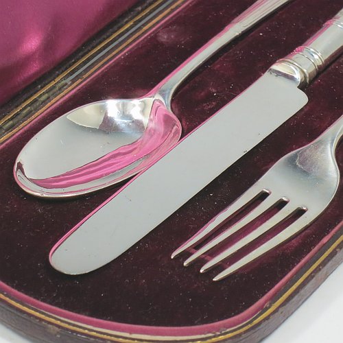 An Antique Victorian Sterling Silver christening set, having a knife, fork, and spoon, all with Albany pattern handles, and all sitting in their original purple satin and velvet-lined presentation box. Made by the William Gibson & John Lawrence of London in 1886 (for Goldsmiths & Silversmiths). The dimensions of this fine hand-made silver christening set are length of knife 20 cms (8 inches), with a total weight of approx. 125g (4 troy ounces).   