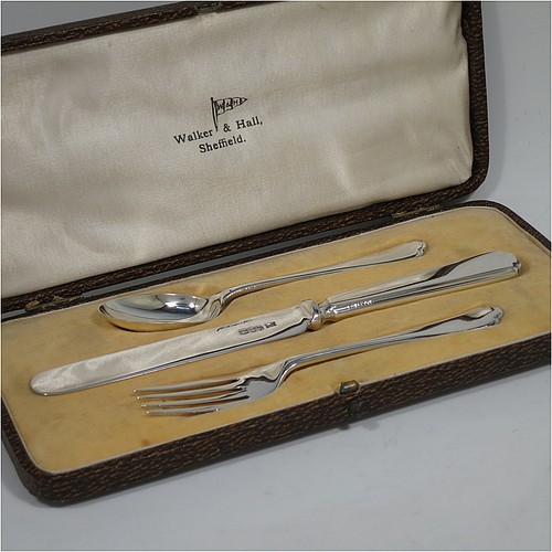 A very handsome Art Deco style Sterling Silver christening set, having a knife, fork, and spoon, all sitting in their original white satin and cream velvet-lined presentation box. Made by Walker and Hall of Sheffield in 1932. The dimensions of this fine hand-made silver christening set are length of knife 19 cms (7.5 inches), with a total weight of approx. 93g (3 troy ounces).    