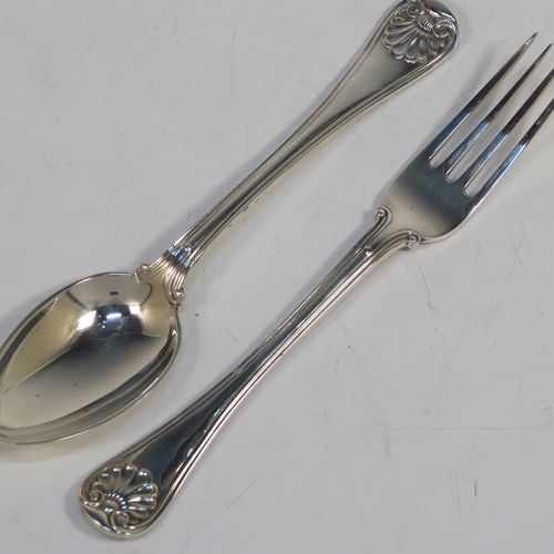 A very handsome Antique Sterling Silver christening set consisting of a plain round napkin ring, a spoon and fork in the double-struck Old English, Thread and Shell pattern, and all in their original cream satin and dark blue velvet-lined presentation box. This elegant silver christening set was mad by Martin Hall and Co., of Sheffield in 1912. The dimensions of this fine hand-made antique silver christening set are length of spoon and fork 16 cms (6.3 inches), diameter of napkin ring 4.5 cms (1.75 inches), and it has a total weight of approx. 124g (4 troy ounces).   