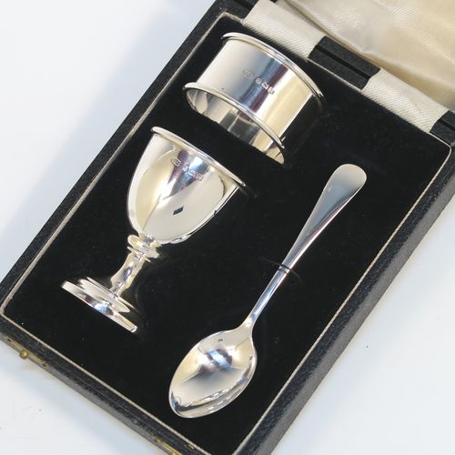 A handsome Sterling Silver three-piece christening set, consisting of a plain round napkin ring, a plain round egg cup, and a plain Old English pattern spoon, all in their original cream satin and black velvet-lined presentation box. This elegant christening set was made by Price and Co.,  of Birmingham in 1933. The dimensions of this fine hand-made silver christening set are length of spoon 11 cms (4.25 inches), diameter of napkin ring 4.5 cms (1.75 inches), and the total weight is approx. 41g (1.3 troy ounces).  