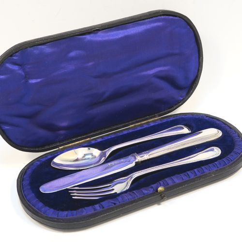 A pretty Antique Edwardian Sterling Silver christening set, having a knife, fork, and spoon, all with double-struck bead-edged pattern handles, and all sitting in their original dark blue satin and velvet-lined presentation box. This beautiful antique boxed christening set was made by Charles Boyton and Sons of London in 1907. The dimensions of this fine hand-made silver christening set are length of knife 19 cms (7.5 inches), with a total weight of approx. 122g (3.9 troy ounces).   