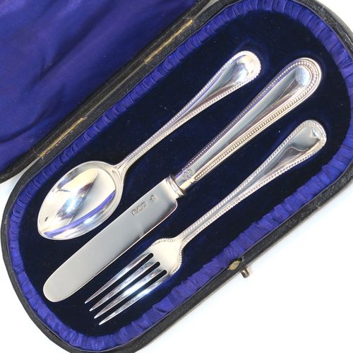 A pretty Antique Edwardian Sterling Silver christening set, having a knife, fork, and spoon, all with double-struck bead-edged pattern handles, and all sitting in their original dark blue satin and velvet-lined presentation box. This beautiful antique boxed christening set was made by Charles Boyton and Sons of London in 1907. The dimensions of this fine hand-made silver christening set are length of knife 19 cms (7.5 inches), with a total weight of approx. 122g (3.9 troy ounces).   