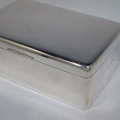 A large and handsome Antique Victorian Sterling Silver cigarette / cigar table box, having a plain rectangular body with nice rounded corners, a hinged lid having an applied thumb-piece, and a cedar wood-lined interior to the base, with a removable divider. Made by A. and J. Zimmerman of Birmingham  in 1898. The dimensions of this fine hand-made antique silver table cigar or cigarette box are length 23.5 cms (9.25 inches), width 15 cms (6 inches), and height 8 cms (3 inches).    