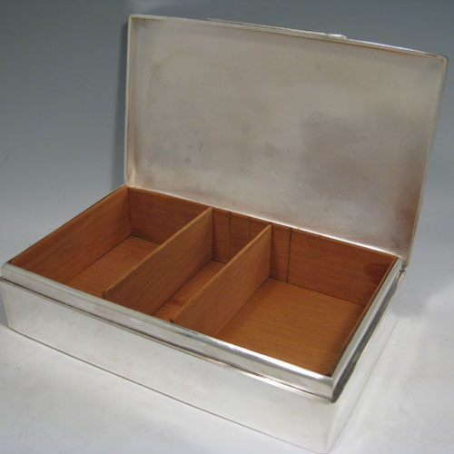 Sterling silver large cigar table box, having a plain rectangular body, a slightly domed and hinged lid with thumbpiece, and cedar wood-lined interior with two removable dividers. Made by Alexander Clarke of London in 1927. The dimensions of this fine silver cigar box are length 25.5 cms (10 inches), width 15 cms (6 inches), and height 6.5 cms (2.5 inches).    