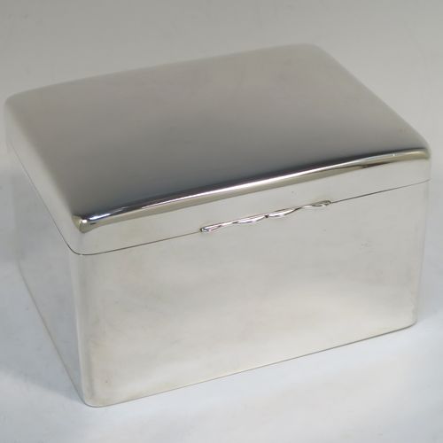 A very elegant Antique Edwardian Sterling Silver cigarette or cigar table box, having a plain rectangular body with nice rounded corners, a hinged lid having an applied thumb-piece, with a gold-gilt and cedar wood-lined interior to the base. This handsome antique silver table box was made by A. and J. Zimmerman of Birmingham in 1904. The dimensions of this fine hand-made antique silver table cigar or cigarette box are length 16 cms (6.25 inches), width 12.5 cms (5 inches), and height 9.5 cms (3.75 inches).   