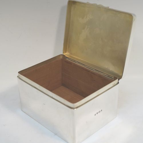 A very elegant Antique Edwardian Sterling Silver cigarette or cigar table box, having a plain rectangular body with nice rounded corners, a hinged lid having an applied thumb-piece, with a gold-gilt and cedar wood-lined interior to the base. This handsome antique silver table box was made by A. and J. Zimmerman of Birmingham in 1904. The dimensions of this fine hand-made antique silver table cigar or cigarette box are length 16 cms (6.25 inches), width 12.5 cms (5 inches), and height 9.5 cms (3.75 inches).   