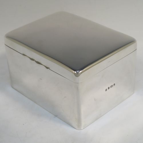 A very elegant Antique Edwardian Sterling Silver cigarette or cigar table box, having a plain rectangular body with nice rounded corners, a hinged lid having an applied thumb-piece, with a gold-gilt and cedar wood-lined interior to the base. This handsome antique silver table box was made by A. and J. Zimmerman of Birmingham in 1904. The dimensions of this fine hand-made antique silver table cigar or cigarette box are length 16 cms (6.25 inches), width 12.5 cms (5 inches), and height 9.5 cms (3.75 inches).   