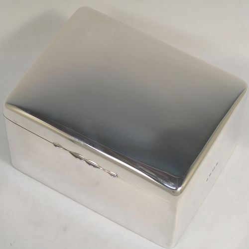 A very elegant Antique Edwardian Sterling Silver cigarette or cigar table box, having a plain rectangular body with nice rounded corners, a hinged lid having an applied thumb-piece, with a gold-gilt and cedar wood-lined interior to the base. This handsome antique silver table box was made by A. and J. Zimmerman of Birmingham in 1904. The dimensions of this fine hand-made antique silver table cigar or cigarette box are length 16 cms (6.25 inches), width 12.5 cms (5 inches), and height 9.5 cms (3.75 inches).   