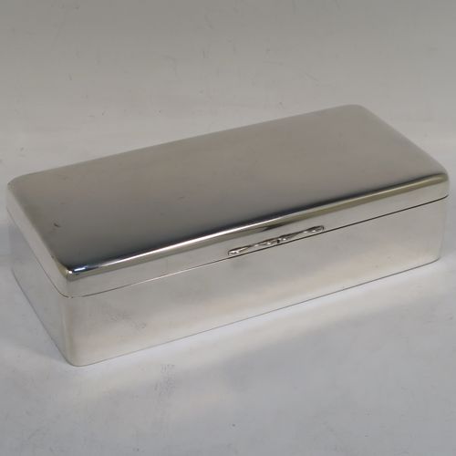 A very elegant Antique Victorian Sterling Silver cigarette / cigar table box, having a plain rectangular body with nice rounded corners, a hinged lid having an applied thumb-piece, a gold-gilt interior, and sitting on a flat base. This handsome antique silver cigar table box was made by A. & J. Zimmerman of Birmingham in 1898. The dimensions of this fine hand-made antique silver table cigar or cigarette box are length 21.5 cms (8.5 inches), width 9.5 cms (3.75 inches), height 6 cms (2.3 inches), and it weighs 640g (20.6 troy ounces). Please note that most old or antique cigar boxes are weighted in the base, and this one is not, so the whole weight is silver.  