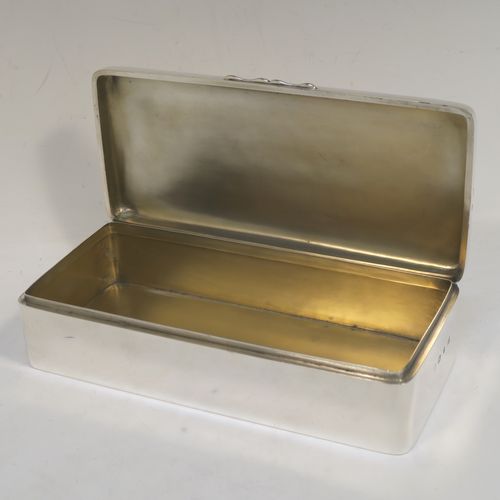 A very elegant Antique Victorian Sterling Silver cigarette / cigar table box, having a plain rectangular body with nice rounded corners, a hinged lid having an applied thumb-piece, a gold-gilt interior, and sitting on a flat base. This handsome antique silver cigar table box was made by A. & J. Zimmerman of Birmingham in 1898. The dimensions of this fine hand-made antique silver table cigar or cigarette box are length 21.5 cms (8.5 inches), width 9.5 cms (3.75 inches), height 6 cms (2.3 inches), and it weighs 640g (20.6 troy ounces). Please note that most old or antique cigar boxes are weighted in the base, and this one is not, so the whole weight is silver.  