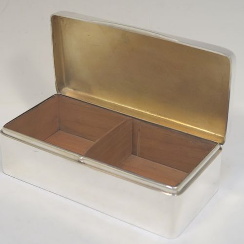 A very handsome Antique Sterling Silver cigarette / cigar table box, having a plain rectangular body with nice rounded corners, a hinged lid having an applied thumb-piece, with a gold-gilt and cedar wood-lined interior to the base, with a removable divider. This elegant antique silver table box was made by Robert Comyns of Birmingham in 1918. The dimensions of this fine hand-made antique silver table cigar or cigarette box are length 18 cms (7 inches), width 9 cms (3.5 inches), and height 6 cms (2.3 inches).   