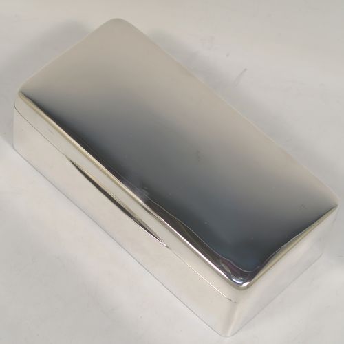 A very handsome Antique Sterling Silver cigarette / cigar table box, having a plain rectangular body with nice rounded corners, a hinged lid having an applied thumb-piece, with a gold-gilt and cedar wood-lined interior to the base, with a removable divider. This elegant antique silver table box was made by Robert Comyns of Birmingham in 1918. The dimensions of this fine hand-made antique silver table cigar or cigarette box are length 18 cms (7 inches), width 9 cms (3.5 inches), and height 6 cms (2.3 inches).   