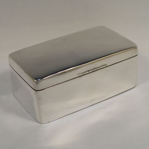 A very handsome Antique Edwardian Sterling Silver cigarette or cigar table box, having a plain rectangular body with nice rounded corners, a hinged lid having an applied thumb-piece, with a cedar wood-lined interior to the base and a removable divider. This elegant antique silver table box was made by A. and J. Zimmerman of Birmingham in 1903. The dimensions of this fine hand-made antique silver table cigar or cigarette box are length 17 cms (6.75 inches), depth 10 cms (4 inches), and height 7 cms (2.75 inches).

  