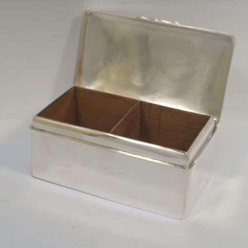 A very elegant Antique Sterling Silver cigarette or cigar table box, having a plain rectangular body with nice rounded corners, a hinged lid having an applied thumb-piece, with a cedar wood-lined interior to the base and a removable divider. This elegant antique silver table box was made by A. and J. Zimmerman of Birmingham in 1913. The dimensions of this fine hand-made antique silver table cigar or cigarette box are length 17 cms (6.75 inches), depth 10 cms (4 inches), and height 7 cms (2.75 inches).   