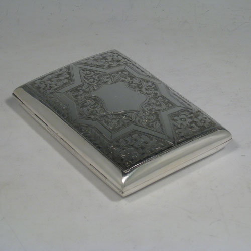 Antique Edwardian sterling silver cigarette / cigarello case, having a rectangular shaped body with rounded edges, hand-engraved floral and geometrical style decoration, central vacant cartouche, and thumb-piece with catch. Made in Chester in 1909. The dimensions of this fine hand-made silver cigar case are length 11.5 cms (4.5 inches), width 8.5 cms (3.3 inches), depth 2 cms (0.75 inch), and the weight is approx. 143g (4.6 troy ounces).   