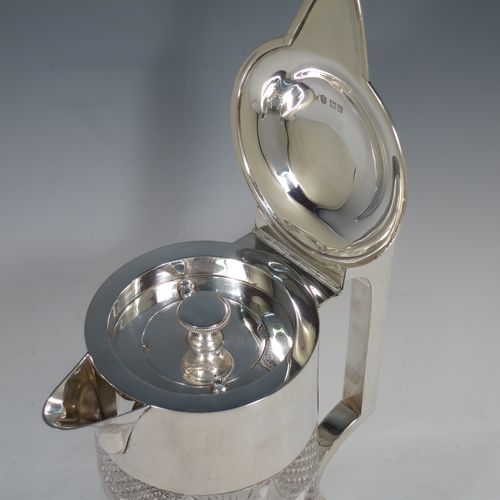 A very handsome and large Antique Victorian Sterling Silver and hand-cut crystal lemonade or pimms jug, having a plain round mount, a hinged lid with a pierced thumb-piece, a plain square cross-section handle, a sparrow-beak style spout, together with an original internal glass tube for crushed ice (with silver  handle and bayonet-fit lift-off lid), a hand-cut crystal body with lobes of hobnail-cut decoration, and all sitting on a flat star-cut base. Made by Streeter and Co. Ltd., of London in 1899. The dimensions of this fine hand-made antique silver and crystal pimms or lemonade jug are height 28 cms (11 inches), length 21 cms (8.25 inches), and diameter at base 17 cms (6.75 inches).   