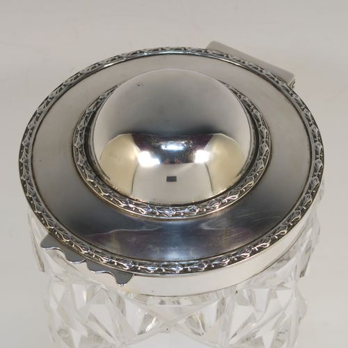 A very unusual and handsome Antique Sterling Silver and hand-cut crystal cocktail mixing jar, having a round crystal body with a hobnail cut, a plain round silver mount and a hinged domed lid with applied floral borders. This elegant silver and crystal cocktail jar was made by Hamilton and Co., of London in 1912. The dimensions of this fine hand-made silver and crystal cocktail mixing jar are height 20.5 cms (8 inches), and diameter at widest point 10 cms (4 inches).  