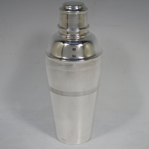 A handsome Silver-Plated Art Deco cocktail shaker, having a plain round body with tapering sides and hand-egraved bands of horizontal reeded decoration, a pull-off lid with knurled border, together with a pull-off strainer section, and the main body with a flat base. Made by Charles Boyton and Sons of Sheffield, England, in ca. 1930. The dimensions of this fine hand-made silver plated cocktail shaker are height 21.5 cms (8.5 inches), diameter at widest point 8.5 cms (3.3 inches).   