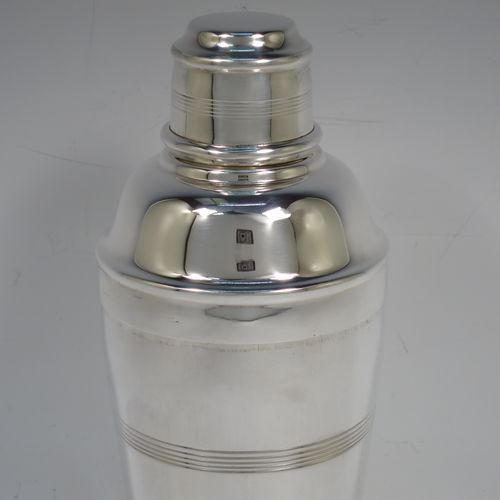 A handsome Silver-Plated Art Deco cocktail shaker, having a plain round body with tapering sides and hand-egraved bands of horizontal reeded decoration, a pull-off lid with knurled border, together with a pull-off strainer section, and the main body with a flat base. Made by Charles Boyton and Sons of Sheffield, England, in ca. 1930. The dimensions of this fine hand-made silver plated cocktail shaker are height 21.5 cms (8.5 inches), diameter at widest point 8.5 cms (3.3 inches).   