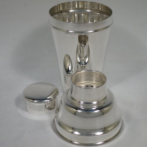 A handsome Silver-Plated Art Deco cocktail shaker, having a plain round body with tapering sides, with a pull-off lid, and strainer section with an applied knurled edge, and the main body with a flat base. Made in Sheffield, England, in ca. 1930. The dimensions of this fine hand-made silver plated cocktail shaker are height 19 cms (7.5 inches), diameter at widest point 9 cms (3.5 inches).    