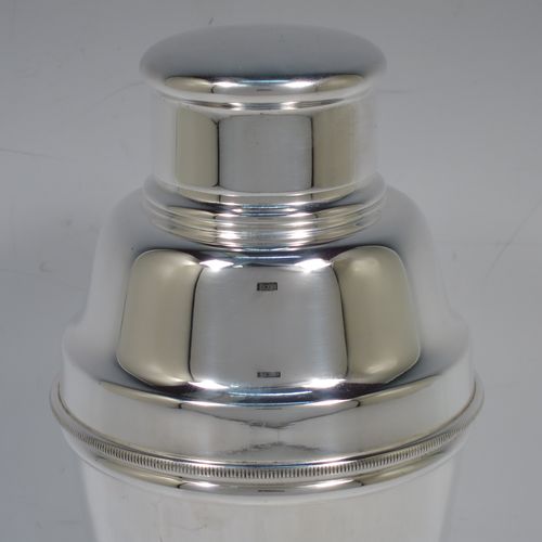 A handsome Silver-Plated Art Deco cocktail shaker, having a plain round body with tapering sides, with a pull-off lid, and strainer section with an applied knurled edge, and the main body with a flat base. Made in Sheffield, England, in ca. 1930. The dimensions of this fine hand-made silver plated cocktail shaker are height 19 cms (7.5 inches), diameter at widest point 9 cms (3.5 inches).    