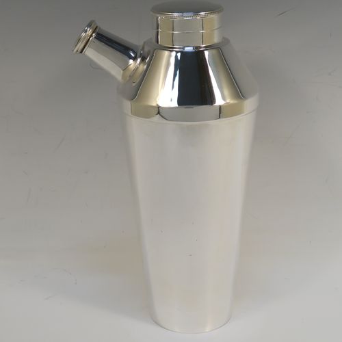 A very elegant Art Deco style Silver-Plated cocktail shaker, having a plain round body with tapering sides, with a screw-off top lid and a pull-off side pouring cap with cork stopper. This handsome silver-plated cocktail shaker was made in ca. 1930. The dimensions of this fine hand-made silver plated cocktail shaker are height 25 cms (9.75 inches), and diameter at widest point 10 cms (4 inches).   