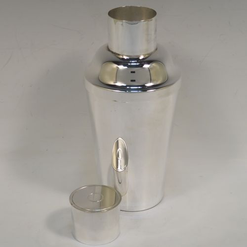 A very handsome Art Deco style Silver-Plated cocktail shaker, having a plain round body with tapering sides, with a pull-off lid and a strainer section. This elegant silver-plated cocktail shaker was made in ca. 1930. The dimensions of this fine hand-made silver plated cocktail shaker are height 18 cms (7 inches), diameter at widest point 8.5 cms (3.3 inches).   