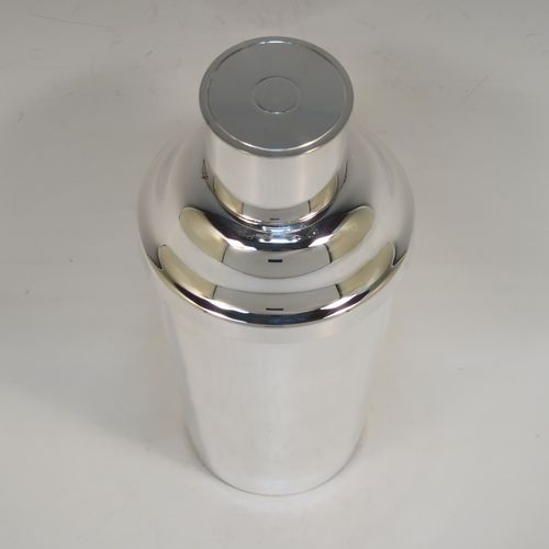 A very handsome Art Deco style Silver-Plated cocktail shaker, having a plain round body with tapering sides, with a pull-off lid and a strainer section. This elegant silver-plated cocktail shaker was made in ca. 1930. The dimensions of this fine hand-made silver plated cocktail shaker are height 18 cms (7 inches), diameter at widest point 8.5 cms (3.3 inches).   