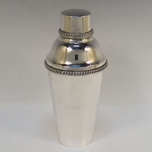 A very handsome Italian 800 Standard Silver Art Deco cocktail shaker, having a plain round body with tapering sides, with a pull-off lid and interior strainer section, with applied gadroon borders to the pull-off parts. This elegant silver cocktail shaker was made Miracoli of Italy in ca. 1960. The dimensions of this fine hand-made silver cocktail shaker are height 20 cms (8 inches), diameter at widest point 9 cms (3.5 inches), and it weighs approx. 380g (12.3 troy ounces).  