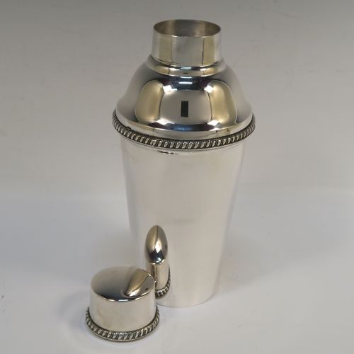 A very handsome Italian 800 Standard Silver Art Deco cocktail shaker, having a plain round body with tapering sides, with a pull-off lid and interior strainer section, with applied gadroon borders to the pull-off parts. This elegant silver cocktail shaker was made Miracoli of Italy in ca. 1960. The dimensions of this fine hand-made silver cocktail shaker are height 20 cms (8 inches), diameter at widest point 9 cms (3.5 inches), and it weighs approx. 380g (12.3 troy ounces).  