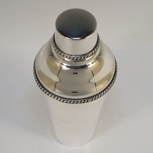 A very handsome Italian 800 Standard Silver Art Deco cocktail shaker, having a plain round body with tapering sides, with a pull-off lid and interior strainer section, with applied gadroon borders to the pull-off parts. This elegant silver cocktail shaker was made Miracoli of Italy in ca. 1960. The dimensions of this fine hand-made silver cocktail shaker are height 20 cms (8 inches), diameter at widest point 9 cms (3.5 inches), and it weighs approx. 380g (12.3 troy ounces).  