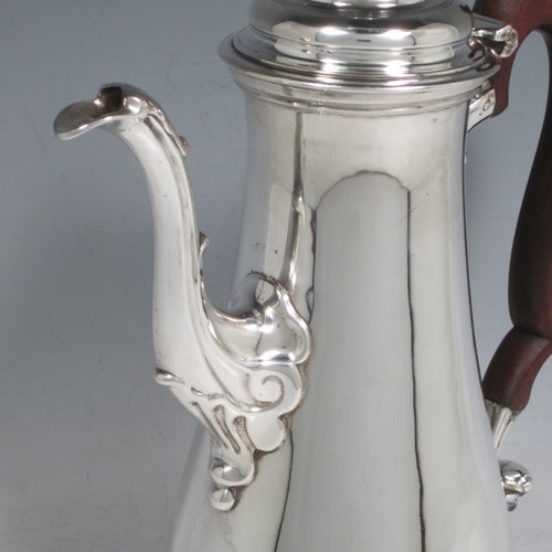 Antique Georgian sterling silver coffee pot, having a plain round baluster body, a domed hinged lid with acorn finial, a scroll spout, and a scrolled wooden handle, sitting on a round pedestal foot. Made by John Mackfarlen (Poss.) of London in 1759. The dimensions of this fine hand-made silver coffee pot are length 20 cms (8 inches), height 26 cms (10.25 inches), and it weighs approx. 800g (26 troy ounces).   