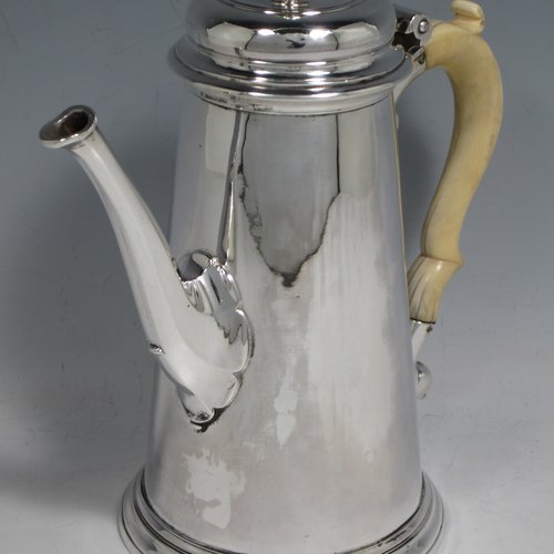 Antique Georgian sterling silver George II coffee pot, having a plain round body with straight tapering sides, a hinged cushion style lid with finial, an octagonal panelled spout, an ivory scroll handle, and all sitting on a collet foot. Made by John Swift of London in 1738. The dimensions of this fine hand-made silver coffee pot are length 18 cms (7 inches), height 20 cms (8 inches), and it weighs approx. 625g (20 troy ounces). Please note that this item shows fire-stain which is acceptable for a piece from this period.