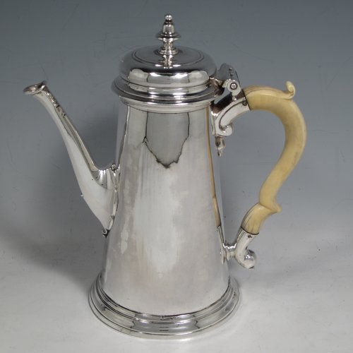 Antique Georgian sterling silver George II coffee pot, having a plain round body with straight tapering sides, a hinged cushion style lid with finial, an octagonal panelled spout, an ivory scroll handle, and all sitting on a collet foot. Made by John Swift of London in 1738. The dimensions of this fine hand-made silver coffee pot are length 18 cms (7 inches), height 20 cms (8 inches), and it weighs approx. 625g (20 troy ounces). Please note that this item shows fire-stain which is acceptable for a piece from this period.