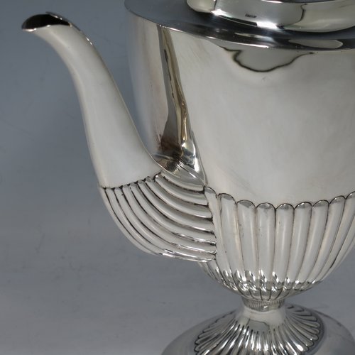 An Antique Victorian Sterling Silver coffee pot, in a Queen Anne style, having an oval tapering body with hand-chased half-fluted decoration, a wooden handle, a hinged lid with an invisible flat hinge and wooden finial, and all sitting on a pedestal foot. Made by Charles Stuart Harris of London in 1885. The dimensions of this fine hand-made antique silver coffee pot are length 22 cms (8.5 inches), height 21 cms (8.25 inches), and it weighs approx. 340g (11 troy ounces).   