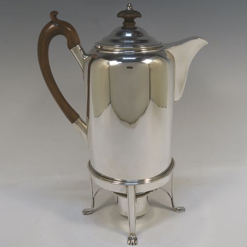 A large and very handsome Antique Georgian sterling silver coffee Biggin pot with an original spirit burner stand, having a very plain round body with straight sides, a brown fruit-wood handle, a pull-off lid with wooden finial, and sitting on a burner stand with four flange feet. This beautiful coffee Biggin pot and burner stand was made by Robert Keay I of Edinburgh in 1807. The dimensions of this fine hand-made coffee pot Biggin on burner stand are length 22 cms (8.75 inches), height 30.5 cms (12 inches), diameter of main body 11 cms (4.5 inches), and it weighs approx. 1,178g (38 troy ounces). 