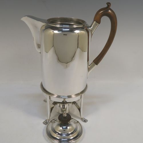 A large and very handsome Antique Georgian sterling silver coffee Biggin pot with an original spirit burner stand, having a very plain round body with straight sides, a brown fruit-wood handle, a pull-off lid with wooden finial, and sitting on a burner stand with four flange feet. This beautiful coffee Biggin pot and burner stand was made by Robert Keay I of Edinburgh in 1807. The dimensions of this fine hand-made coffee pot Biggin on burner stand are length 22 cms (8.75 inches), height 30.5 cms (12 inches), diameter of main body 11 cms (4.5 inches), and it weighs approx. 1,178g (38 troy ounces). 