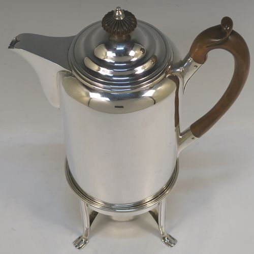 A large and very handsome Antique Georgian sterling silver coffee Biggin pot with an original spirit burner stand, having a very plain round body with straight sides, a brown fruit-wood handle, a pull-off lid with wooden finial, and sitting on a burner stand with four flange feet. This beautiful coffee Biggin pot and burner stand was made by Robert Keay I of Edinburgh in 1807. The dimensions of this fine hand-made coffee pot Biggin on burner stand are length 22 cms (8.75 inches), height 30.5 cms (12 inches), diameter of main body 11 cms (4.5 inches), and it weighs approx. 1,178g (38 troy ounces). 