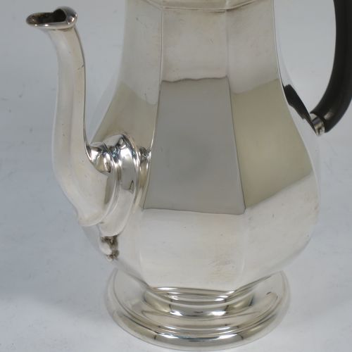 A handsome Antique Sterling Silver small coffee pot for two people, having a plain panelled and bellied body, with a black wooden scroll handle, a hinged and panelled domed lid with cast finial, and all sitting on a pedestal feet. Made by the Goldsmiths & Silversmiths of London in 1913. The dimensions of this fine hand-made antique sterling silver small coffee pot are height 17 cms (6.75 inches), length 14.5 cms (5.75 inches), and it weighs approx. 250g (8 troy ounces).    