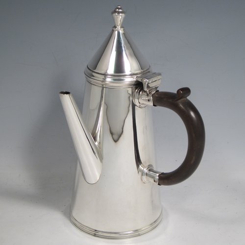 Antique Sterling silver fine hand-made William & Mary style coffee pot, having a very plain round body with tapering sides, a conical hinged lid with finial, a straight spout, and a wooden looped side-handle, all sitting on a raised base. Made by Thomas Bradbury & Sons of London in 1911. The dimensions of this fine silver coffee pot are length 12 cms (4.75 inches), height 22 cms (8.5 inches), and it weighs approx. 400g (13 troy ounces).   