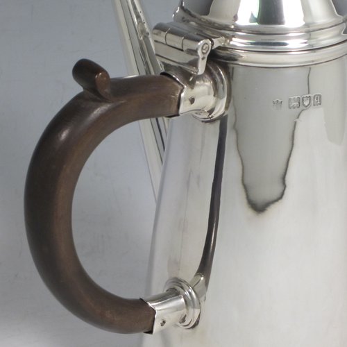 Antique Sterling silver fine hand-made William & Mary style coffee pot, having a very plain round body with tapering sides, a conical hinged lid with finial, a straight spout, and a wooden looped side-handle, all sitting on a raised base. Made by Thomas Bradbury & Sons of London in 1911. The dimensions of this fine silver coffee pot are length 12 cms (4.75 inches), height 22 cms (8.5 inches), and it weighs approx. 400g (13 troy ounces).   