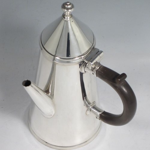 Antique Sterling silver fine hand-made William & Mary style coffee pot, having a very plain round body with tapering sides, a conical hinged lid with finial, a straight spout, and a wooden looped side-handle, all sitting on a raised base. Made by Thomas Bradbury & Sons of London in 1911. The dimensions of this fine silver coffee pot are length 12 cms (4.75 inches), height 22 cms (8.5 inches), and it weighs approx. 400g (13 troy ounces).   