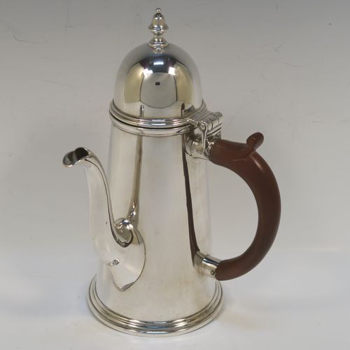 A very handsome Antique Sterling Silver George I style side-handled coffee pot, having a plain round body with straight tapering sides, a hinged domed lid with cast urn-shaped finial, a curved  spout, a hand-carved brown-stained wooden scroll handle, and all sitting on a collet foot. This elegant silver coffee-pot was made by P and F of Sheffield in 1917. The dimensions of this fine hand-made antique silver side-handled coffee pot are length 12.5 cms (5 inches), height 21.5 cms (8.5 inches), and it weighs approx. 465g (15 troy ounces).  