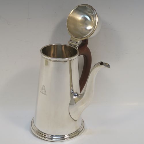 A very handsome Antique Sterling Silver George I style side-handled coffee pot, having a plain round body with straight tapering sides, a hinged domed lid with cast urn-shaped finial, a curved  spout, a hand-carved brown-stained wooden scroll handle, and all sitting on a collet foot. This elegant silver coffee-pot was made by P and F of Sheffield in 1917. The dimensions of this fine hand-made antique silver side-handled coffee pot are length 12.5 cms (5 inches), height 21.5 cms (8.5 inches), and it weighs approx. 465g (15 troy ounces).  