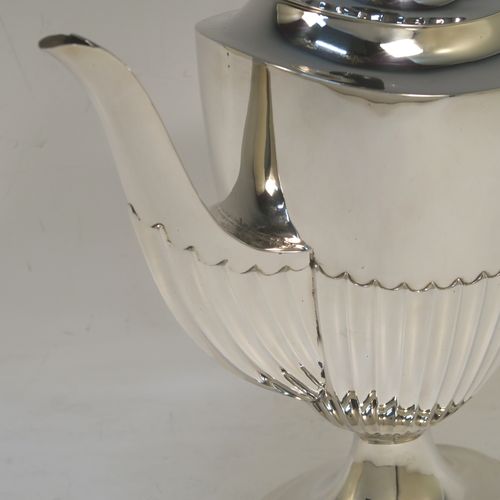 A pretty Antique Victorian Sterling Silver coffee pot, in a Queen Anne style, having an oval tapering body with hand-chased half-fluted decoration, a black wooden handle, a hinged lid with an invisible flat hinge and wooden finial, and all sitting on a pedestal foot. This beautiful antique silver coffee pot was made by Charles Stuart Harris of London in 1899. The dimensions of this fine hand-made antique silver coffee pot are length 22.5 cms (8.75 inches), height 23.5 cms (9.25 inches), and it weighs approx. 450g (14.5 troy ounces)   