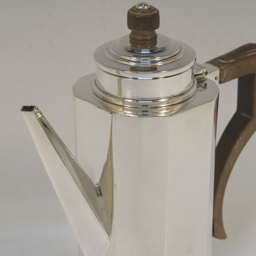 A very elegant Art Deco style Sterling Silver bachelor size coffee pot, having a straight-sided panelled body, a brown wooden side-handle with stepped thumb-piece, a stepped hinged lid with wooden finial, a straight panelled spout, and all sitting on a collet foot. This beautiful silver Art Deco coffee pot was made by Charles S. Green & Co. Ltd., of Birmingham in 1933. This Art Deco coffee pot would be suitable for serving two people and the dimensions of this fine hand-made silver coffee pot are length 16 cms (6.25 inches), height 16.5 cms (6.5 inches), and it weighs approx. 280g (9 troy ounces).  