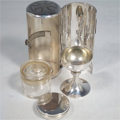 A rare Sterling Silver three-piece travelling communion set consisting of a hand-hammered chalice, pyx box with lid, and glass wine holder with stopper, all in their original silver cylindrical hinged travelling box with a hand-chased christogram. Made by Frederick Osborne & Co., of London in 1930. The dimensions of this fine hand-made silver travelling communion set are length of box 9.5 cms (3.75 inches), and diameter 4.5 cms (1.75 inches), and with a total weight of approx. 250g (8 troy ounces). Please note that it is very unusual to find an original pyx box in a travelling communion set.