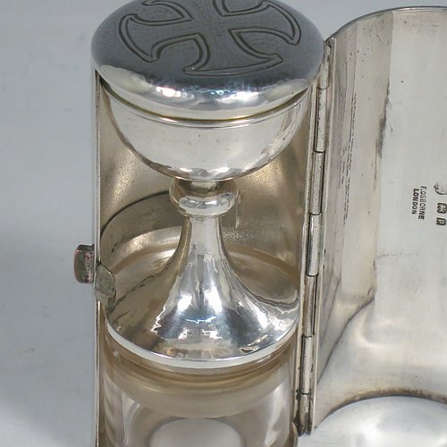 A rare Sterling Silver three-piece travelling communion set consisting of a hand-hammered chalice, pyx box with lid, and glass wine holder with stopper, all in their original silver cylindrical hinged travelling box with a hand-chased christogram. Made by Frederick Osborne & Co., of London in 1930. The dimensions of this fine hand-made silver travelling communion set are length of box 9.5 cms (3.75 inches), and diameter 4.5 cms (1.75 inches), and with a total weight of approx. 250g (8 troy ounces). Please note that it is very unusual to find an original pyx box in a travelling communion set.