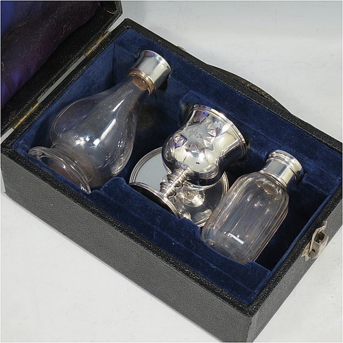 An Antique Georgian (William IV) Sterling Silver four-piece travelling communion set consisting of chalice, paten, water, and wine bottle. The chalice having a plain round bellied body, a gold-gilt interior, and sitting on a round pedestal foot. The paten having a round body with an applied reeded border, and sitting on a collet foot. The wine and water bottles having plain round screw-off lids, cork seals, and hand-cut crystal bodies. All sitting in their original dark blue satin and velvet-lined presentation box. The chalice & paten were made in London in 1835, whilst the bottles are matching and made in London in ca. 1920s. The dimensions of this fine hand-made silver travelling communion set are height of chalice 8 cms (3.25 inches), diameter of paten 6.5 cms (2.5 inches), and with a total weight of approx. 100g (3.2 troy ounces). Please note that the chalice & paten are engraved with a Christogram. 